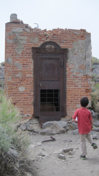 This is the Bodie Bank. Owen is looking at the only thing that survived the 1932 fire. What do you think it is? Answer: the vault.